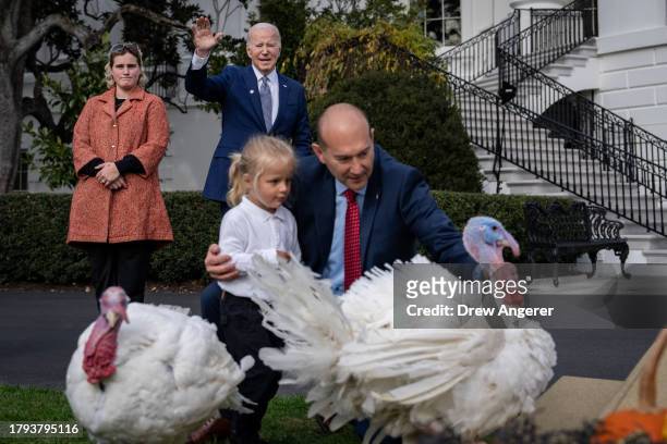 Standing next to his granddaughter Maisy, U.S. President Joe Biden waves after pardoning National Thanksgiving turkeys Liberty and Bell during a...