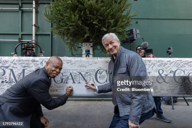 Jamie Dimon, chief executive officer of JPMorgan Chase & Co., right, and Eric Adams, mayor of New York, left, sign a steel beam during an event at...