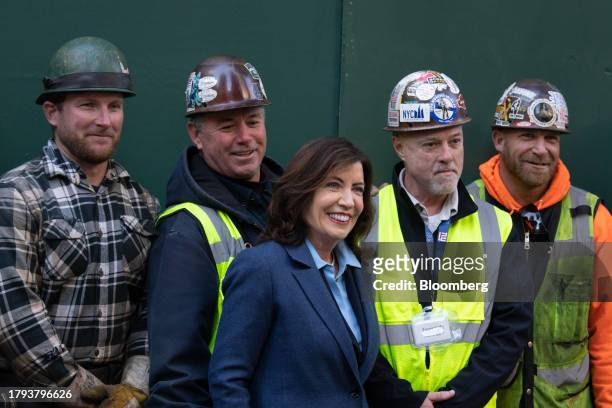 Kathy Hochul, governor of New York, takes a photograph with construction workers during an event at 270 Park Avenue, JPMorgan Chase's new global...