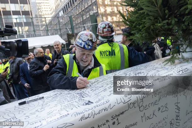 Construction worker signs a steel beam during an event at 270 Park Avenue, JPMorgan Chase's new global headquarters building, in New York, US, on...