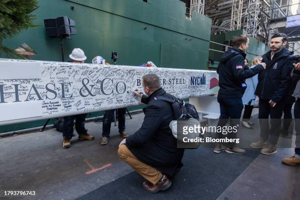 An attendee signs a steel beam during an event at 270 Park Avenue, JPMorgan Chase's new global headquarters building, in New York, US, on Monday,...