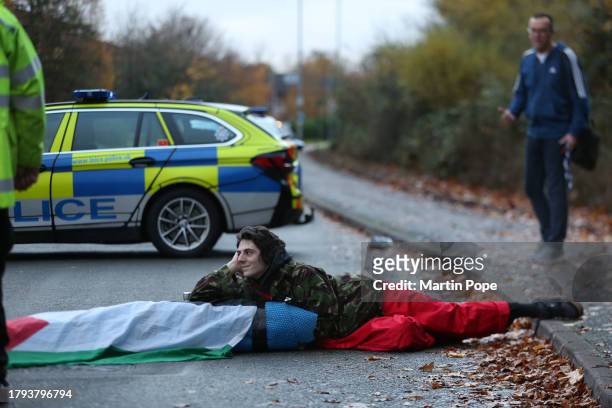 Passer-by trying to get to work remonstrates with one of the activists on November 20, 2023 in Leicester, United Kingdom. Activists with the group...