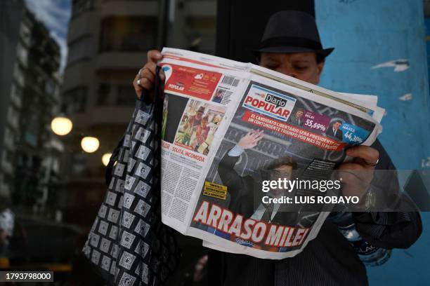 Man reads an Argentine newspaper on November 20 in Buenos Aires, which frontpage shows the victory of the La Libertad Avanza alliance candidate...