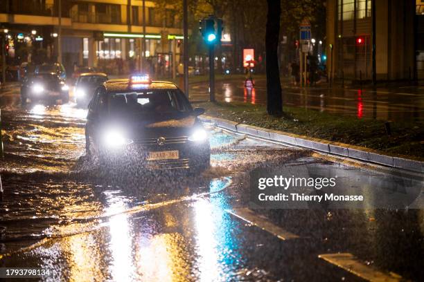 Cars pass through puddles after the rain on the Chaussée d'Etterbeek on November 20, 2023 in Brussels, Belgium. This Monday marked the return of rain...