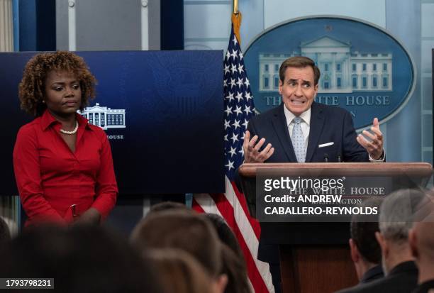 National Security Council spokesman John Kirby speaks as White House press secretary Karine Jean-Pierre looks on during the daily briefing at the...