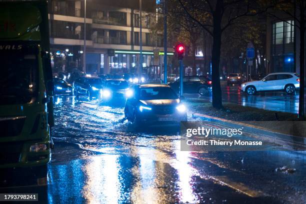 Cars pass through puddles after the rain on the Chaussée d'Etterbeek on November 20, 2023 in Brussels, Belgium. This Monday marked the return of rain...