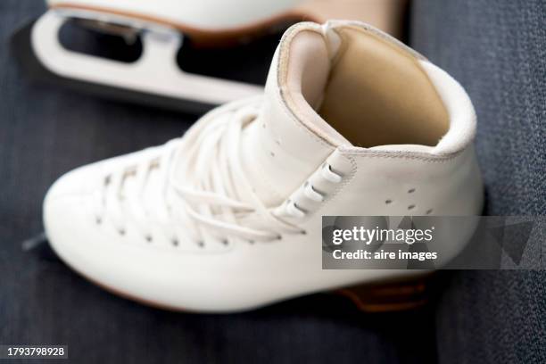 somewhat angled view of a sample of an empty pair of white figure skating boots. - figure skating pair stock pictures, royalty-free photos & images