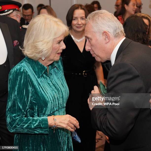 Queen Camilla speaks to a guest at the annual awards ceremony which is celebrating its 135th anniversary at Sheraton Grand London Park Lane on...