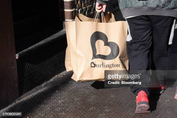 Shopper carries Burlington bags in New York, US, on Monday, Nov. 20, 2023. Burlington Stores Inc. Is scheduled to release earnings figures on...