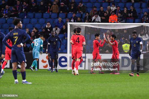 Of South Korea celebrates and Lucas GOURNA-DOUATH of France and Elye WAHI of France and Lesley UGOCHUKWU of France look dejected during the friendly...