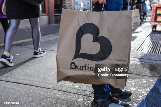 Shopper carries a Burlington bag in New York, US, on Monday, Nov. 20, 2023. Burlington Stores Inc. Is scheduled to release earnings figures on...
