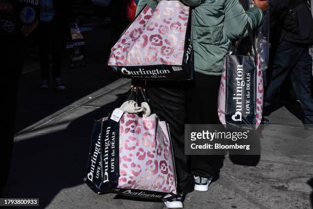 Shopper carries Burlington bags in New York, US, on Monday, Nov. 20, 2023. Burlington Stores Inc. Is scheduled to release earnings figures on...