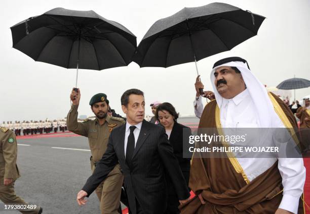 Qatar Sheikh Hamad bin Khalifa Al-Thani welcomes France's President Nicolas Sarkozy at Doha airport, 14 January 2008. After visiting Saudi Arabia,...