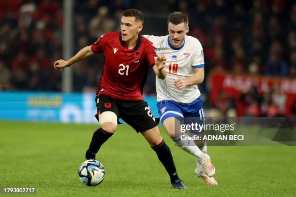 Albania's midfielder Kristjan Asllani fights for the ball with Faroes' midfielder Solvi Vatnhamar during the UEFA Euro 2024 group E qualification...