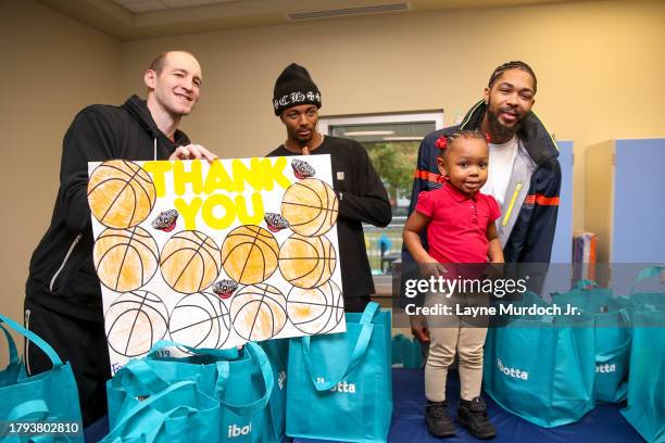 Brandon Ingram, Trey Murphy and Cody Zeller of the of the New Orleans Pelicans giveaway turkeys in New Orleans, Louisiana on November 15, 2023. NOTE...