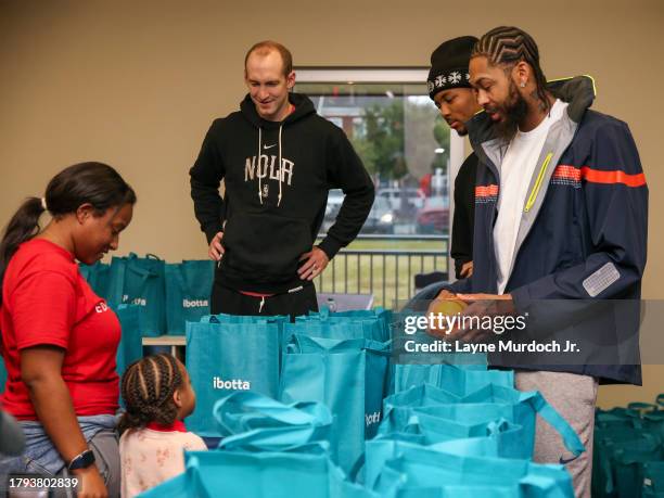 Brandon Ingram, Trey Murphy and Cody Zeller of the of the New Orleans Pelicans giveaway turkeys in New Orleans, Louisiana on November 15, 2023. NOTE...