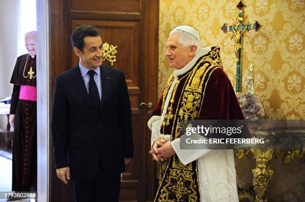 Pope Benedict XVI meets with French president Nicolas Sarkozy as US Monsignor James Harvey looks on during a private audience at the Vatican, 20...