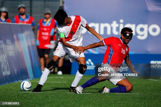 Chile's Benjamin Cobian fights for the ball with Peru's Tony Estrada during the blind football men's team preliminary match between Chile and Peru...