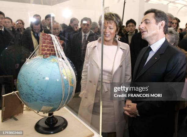 French President Nicolas Sarkozy looks at "The earth in the Eye of Extraterrestrial" by Chinese artist Song Haidong as he visits an exhibition at the...