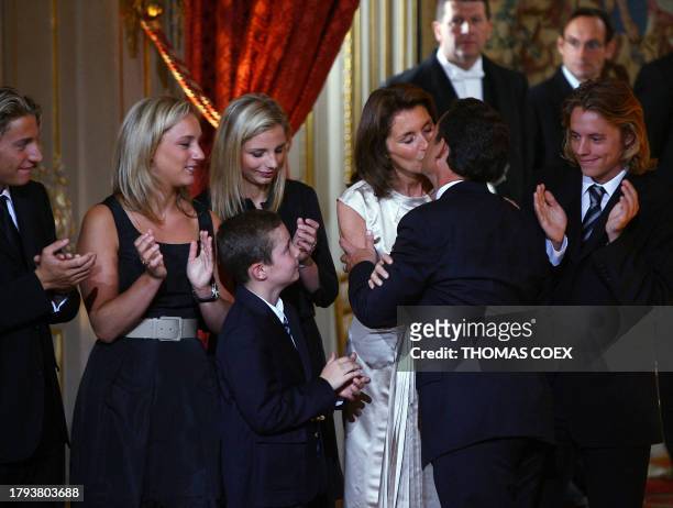 Nicolas Sarkozy kisses his wife Cecilia, next to son Jean, daughters-in-law Jeanne-Marie and Judith, son Louis and son Pierre before being officially...