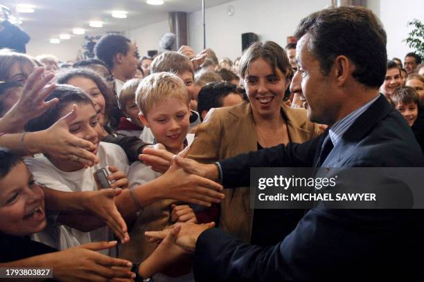 French President Nicolas Sarkozy greets children prior to inaugurate the George Mandel college, 05 October 2007 in Issy-les-Moulineaux, outside...