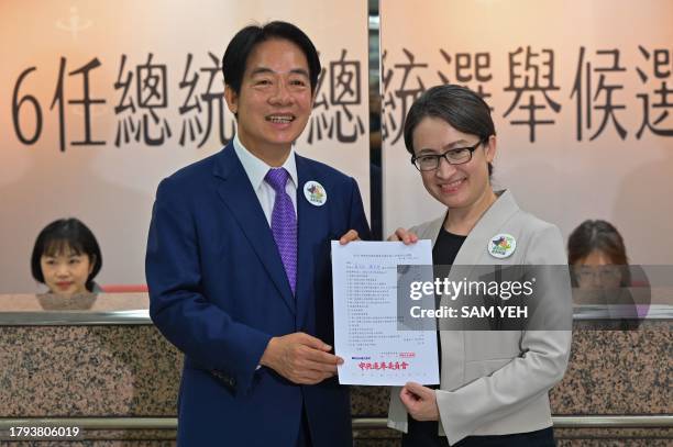 Taiwan presidential candidate Lai Ching-te and his running mate Hsiao Bi-khim , from the ruling Democratic Progressive Party , display a document at...