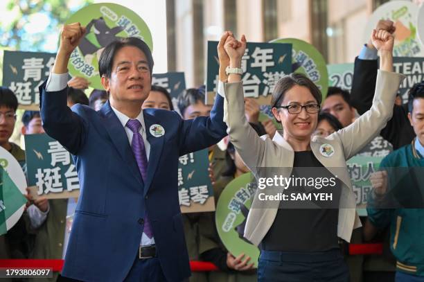 Taiwan presidential candidate Lai Ching-te and his running mate Hsiao Bi-khim , from the ruling Democratic Progressive Party , gesture in front of...