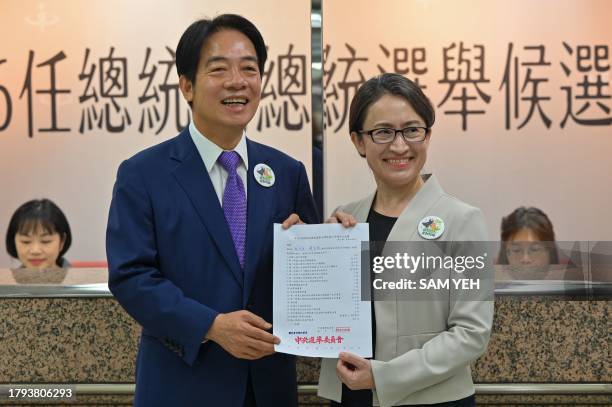 Taiwan presidential candidate Lai Ching-te and his running mate Hsiao Bi-khim , from the ruling Democratic Progressive Party , display a document at...