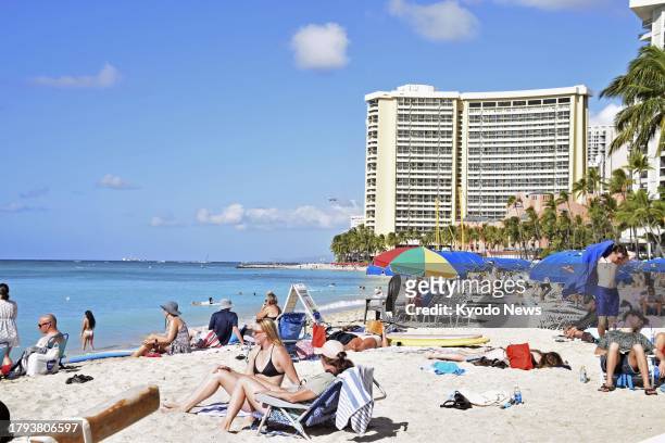 Tourists soak up the sun at Waikiki Beach in Honolulu on Hawaii's Oahu island on Nov. 17, 2023.