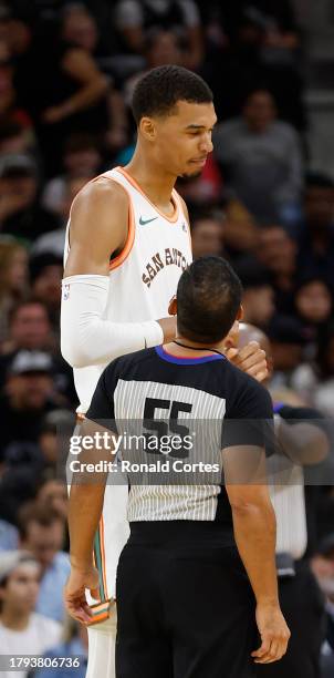 Victor Wembanyama of the San Antonio Spurs talks with official Bill Kennedy during game against the Los Angeles Clippers in the first half at Frost...