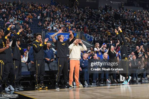 Golden State Warriors bench celebrates three point basket during the game against the Houston Rockets on November 20, 2023 at Chase Center in San...
