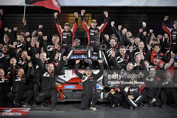 British driver Elfyn Evans and Toyota Motor Corp. Chairman Akio Toyoda pose with team staff at Toyota Stadium in Toyota, Aichi Prefecture, central...