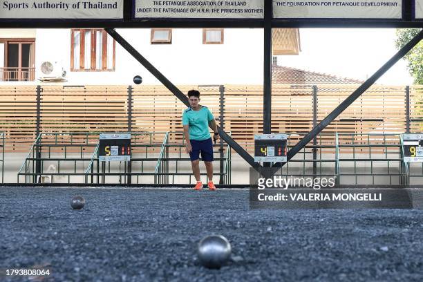 This photo taken on November 8, 2023 shows petanque players train at a court in Bangkok. Half a world away from its home in the sunny squares of...