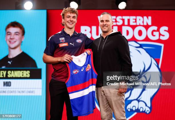 Ryley Sanders is seen with Lindsay Gilbee after being selected at number six by the Western Bulldogs during the 2023 AFL Draft at Marvel Stadium on...