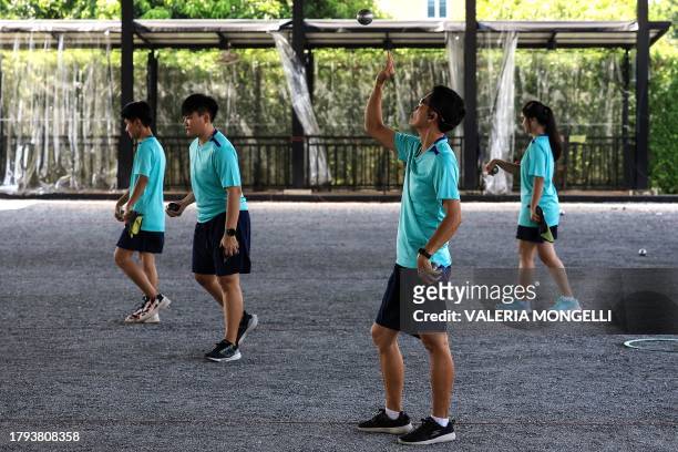 This photo taken on November 8, 2023 shows petanque players training at a court in Bangkok. Half a world away from its home in the sunny squares of...