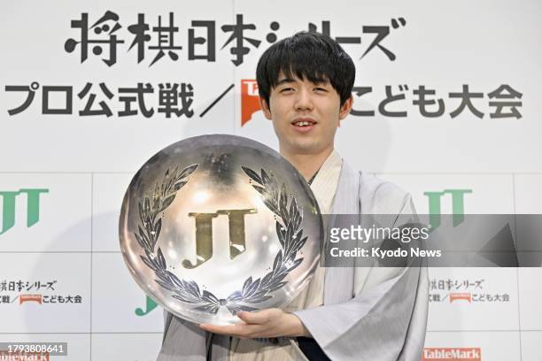 Shogi eight titles holder Sota Fujii poses at a press conference in Tokyo on Nov. 19 after winning the Japan Tobacco Cup -- an annual tournament...