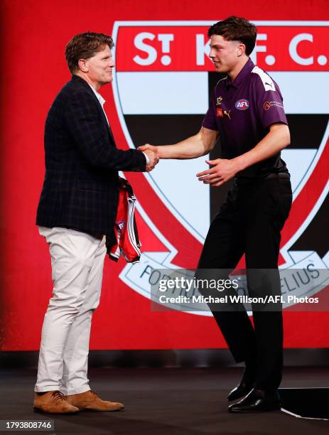 Darcy Wilson is seen with Robert Harvey after being selected at number 18 by St Kilda during the 2023 AFL Draft at Marvel Stadium on November 20,...