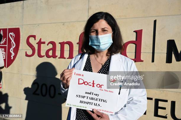 Doctor Yusra Hussain holds a sign that says, ''I'm a Doctor from Palo Alto and I say Stop Targeting Hospitals'' as Stanford doctors, nurses and...