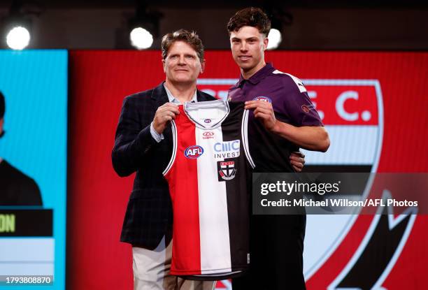 Darcy Wilson is seen with Robert Harvey after being selected at number 18 by St Kilda during the 2023 AFL Draft at Marvel Stadium on November 20,...