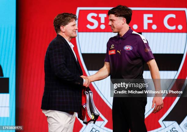 Darcy Wilson is seen with Robert Harvey after being selected at number 18 by St Kilda during the 2023 AFL Draft at Marvel Stadium on November 20,...