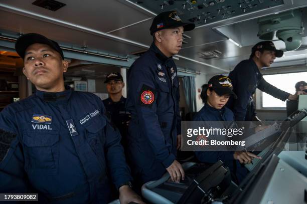 Philippine Coast Guard personnel on the lookout during a resupply mission for the BRP Sierra Madre, in the disputed South China Sea, on Friday, Nov....