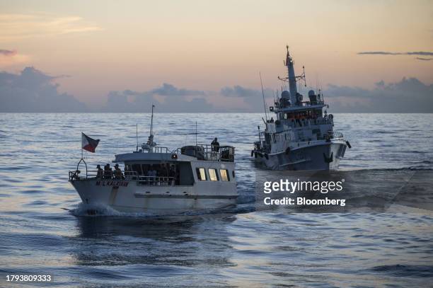Chartered boat ML Kalayaan moves past a China Coast Guard ship during a resupply mission for the BRP Sierra Madre, in the Second Thomas Shoal in the...