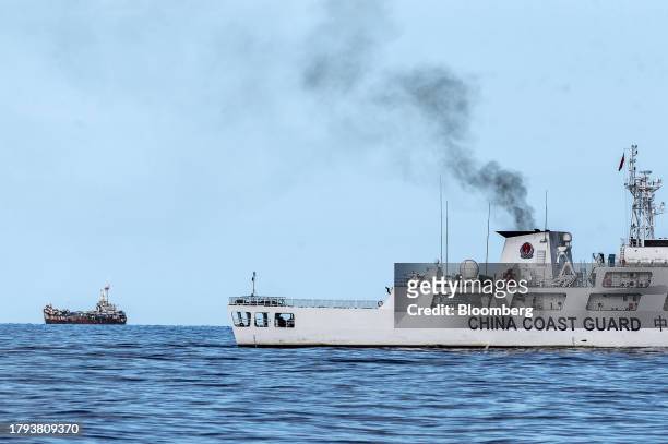 China Coast Guard vessel and the BRP Sierra Madre in the disputed South China Sea, on Friday, Nov. 10, 2023. Both China and the Philippines lay...
