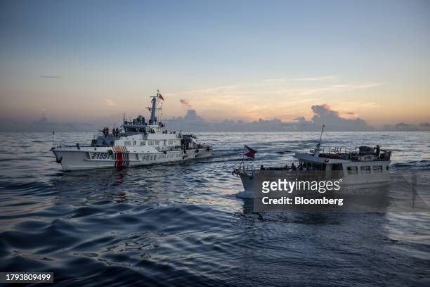 The Philippines' military-chartered boat ML Kalayaan near a China Coast Guard ship during a resupply mission for the BRP Sierra Madre, in the Second...