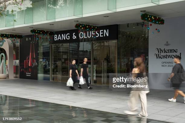Shoppers walk past a Bang & Olufsen A/S store on Scotts Road in Singapore, on Monday, Nov. 20, 2023. Singapore's gross domestic product figures for...