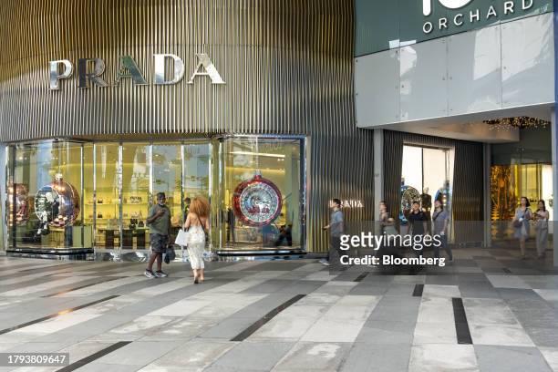 Shoppers in front of the Prada SpA store in Singapore, on Monday, Nov. 20, 2023. Singapore's gross domestic product figures for the third quarter are...