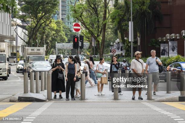 Pedestsrians at a crossing on Orchard Road in Singapore, on Monday, Nov. 20, 2023. Singapore's gross domestic product figures for the third quarter...