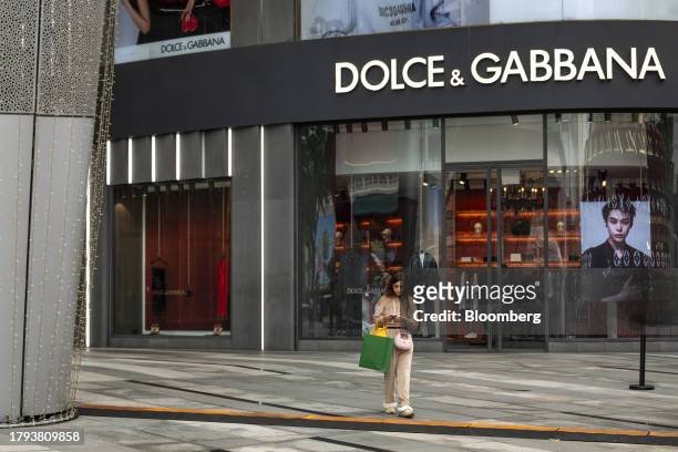 Shopper in front of a Dolce & Gabbana Srl store in Singapore, on Monday, Nov. 20, 2023. Singapore's gross domestic product figures for the third...