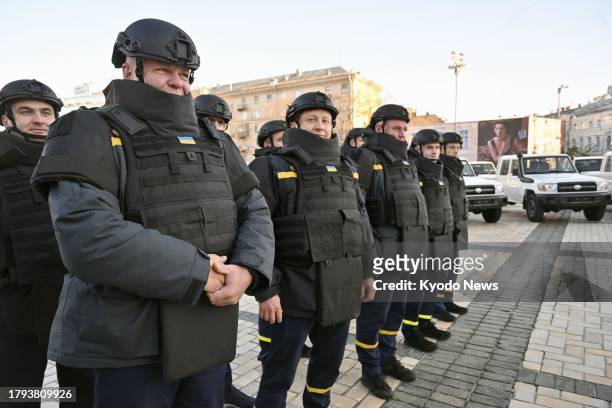 Members of Ukraine's State Emergency Service attend a handover ceremony on Nov. 20 in the country's capital Kyiv, when the Japan International...