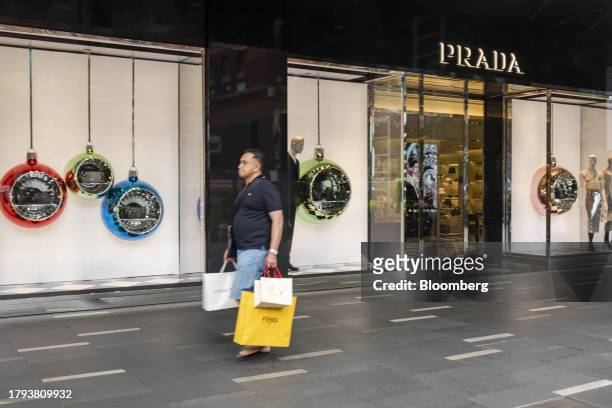 Shopper walks past a Prada SpA store on Orchard Road in Singapore, on Monday, Nov. 20, 2023. Singapore's gross domestic product figures for the third...